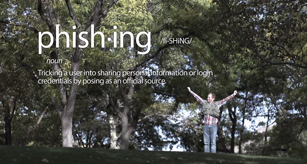 Screen capture of the Phishing Lessons video, showing the definition of phishing: Tricking a user into sharing personal information or login credentials by posing as an official source.