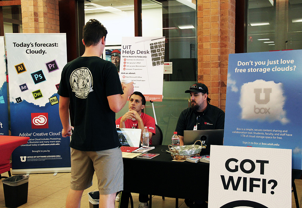 Network Operations Engineer Christian Johnson and University Television student-worker Joshua Vasquez answer questions Friday, August 17, 2018, during a UIT help desk event at Heritage Center.