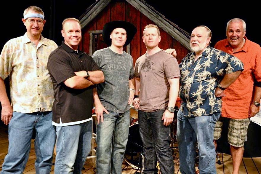 Leduc, second from right, plays bass guitar in the country-rock band Red Rock Country.