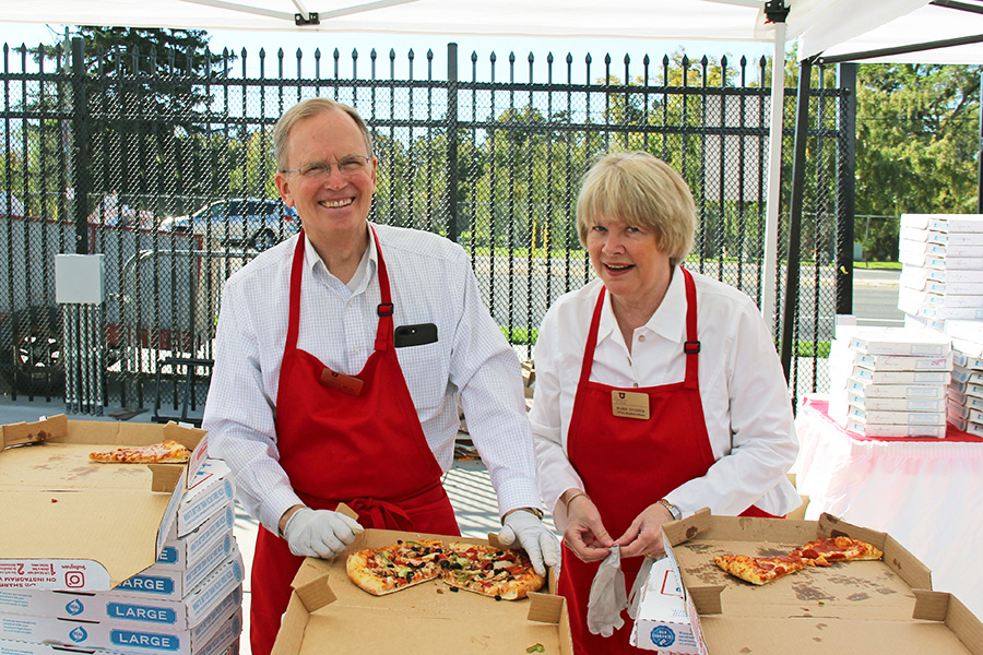 Calling on his food service experience with Lagoon and Utah Food Services, CIO Steve Hess dishes out pizza at Employee Appreciation Day 2018. Also pictured:  VP for Student Affairs Barb Snyder. 