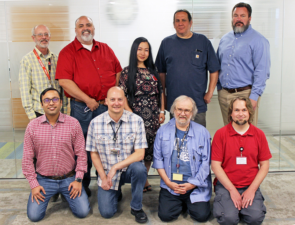 Front, L-R: Rohit Pant, Josh Gross, Cody Hudson, and Daniel Burtenshaw. Back, L-R: Bryan Wooten, Warren Malupo, Tina Nguyen, Steve Adams, and Chris Stucker. Not pictured: Vaibhav Narula.