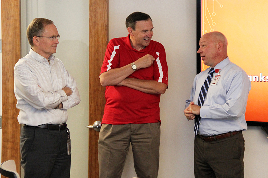 L-R: Chief Information Officer Steve Hess, Deputy CIO Ken PInk, and outgoing Chief Information Security Officer Randy Arvay speak during Arvay's farewell reception July 12 at 102 Tower. Arvay has accepted a position as CISO at Duke University Health System.