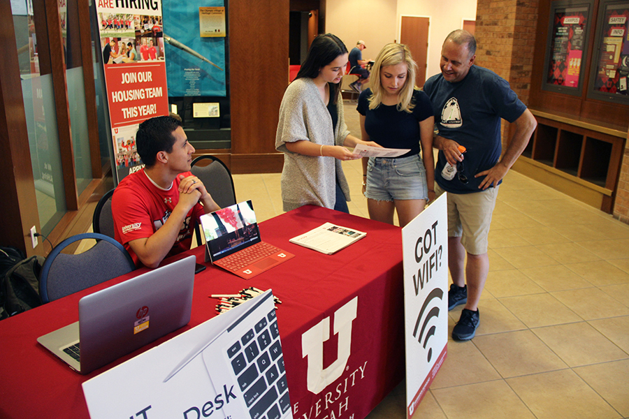 From left, Joshua Vasquez and Rachel Roser of UIT's University Television (UTV) group assist an incoming freshman on August 15 at Heritage Center.