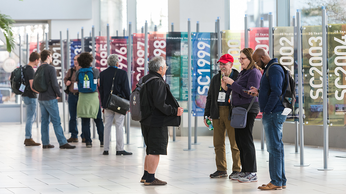 SC19 attendees gather to take photos and view panels with details about previous conferences. (Courtesty of SC Photography)
