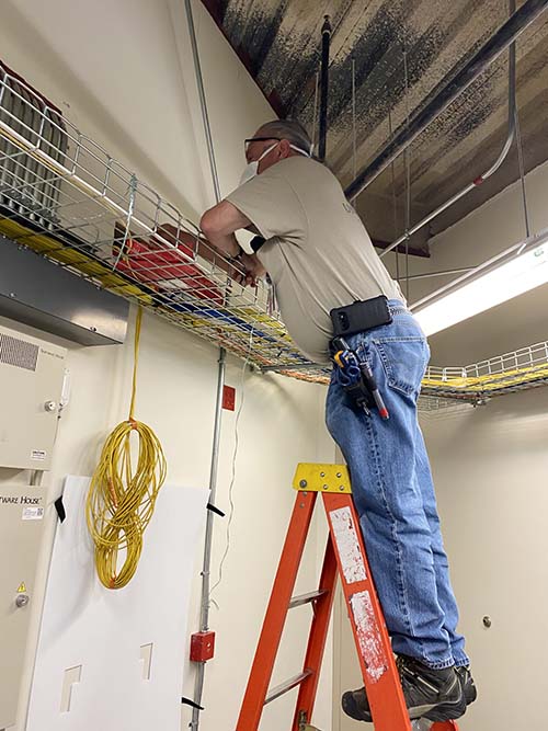 Mike Tyler installs cable on August 25, 2020 at University of Utah Hospital's West Pavilion (photo courtesy of Liz Navarro)