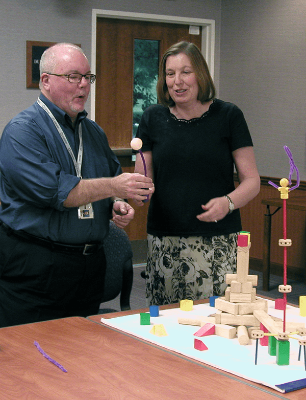 (Courtesy of Chris Pfeiffer) Paul Burrows, left, and Paula Millington create a visual model that represents the strategic topic or theme their team was developing.