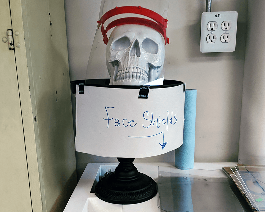 A fake skull with a sign points to where people should drop off 3D-printed and laser-cut pieces to make face shields at Make Salt Lake. (Courtesy of Beth Sallay)