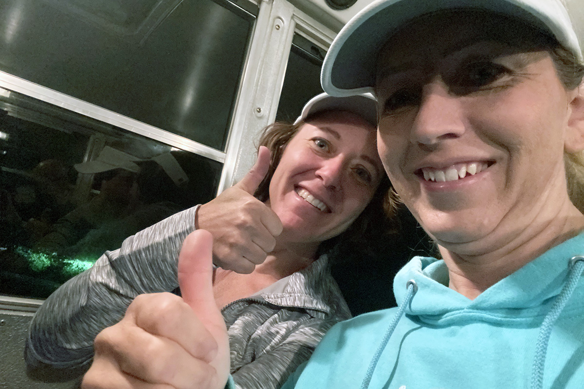 Sheedy, left, and her sister Ruth Carter, ride a shuttle bus to the starting line of the Beaver Canyon race.