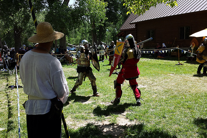 Sageser, in the red jupon (an armor-covering tunic), takes part in close contact combat at a tournament at the Kingdom of Artemesia 20-year celebration.
