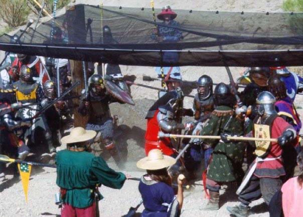 This photo was taken during the Estrella War near Las Vegas approximately 20 years ago. The event featured a fight among four principle kingdoms. Sageser, in red, is demonstrating what happens if you charge a spear line by yourself.  "You can see the king of Caid with his spear in my ribs, but I’m already falling down from the two spears that hit me in the face half a second before," he said.