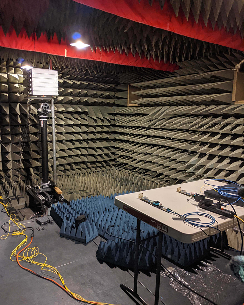 In the photo above, a 48-antenna Skylark mMIMO array sits alongside two 2-antenna clients inside an anechoic chamber within the Department of Electrical and Computer Engineering.