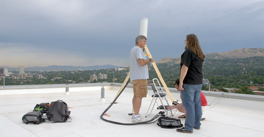 Researchers on the roof of the Donna Garff Marriott Honors Residential Scholars Community are shown in a screenshot from a video about the POWDER-RENEW project produced by the Utah Education and Telehealth Network (UETN).