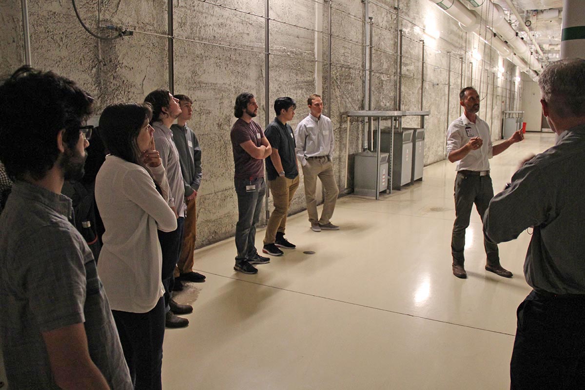 Chris Pederson, right, facing the camera, gives a tour of the Downtown Data Center to UIT student employees.
