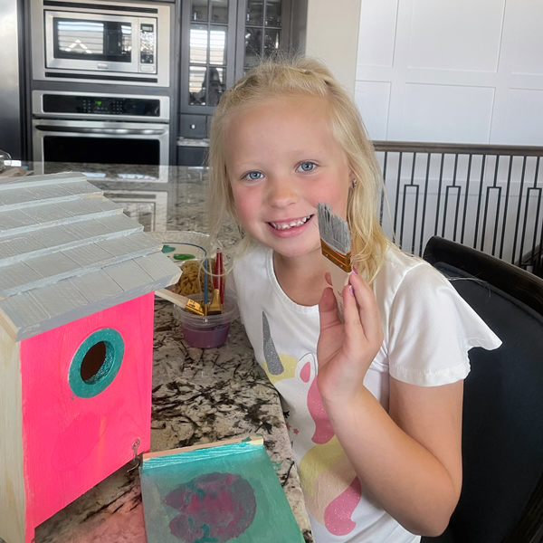 Aimee Ellett's granddaughter, Blakely, paints a birdhouse.