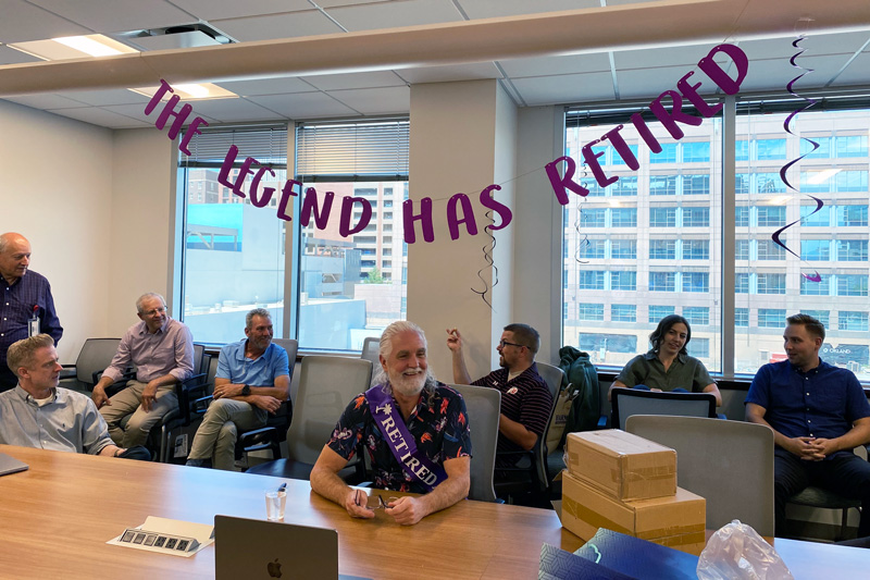 Colleagues celebrate Bryan Harman (center), who retired on July 31, 2023.