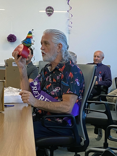 Harman examines the gnome he received as a retirement gift.