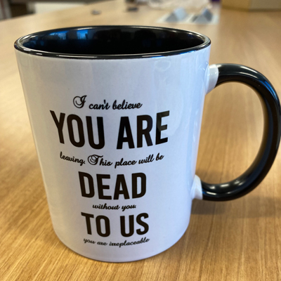 Harman received a mug that reads, "I can't believe YOU ARE leaving. This place will be DEAD without you. TO US you are irreplaceable," with emphasis on "YOU ARE DEAD TO US."