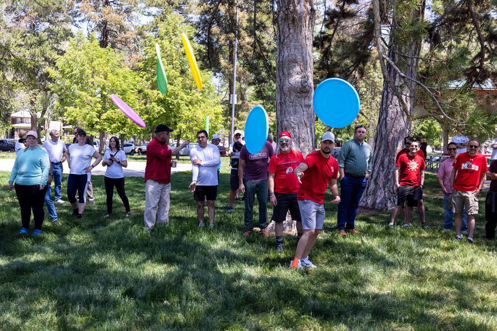 An SPS employee tosses five flying discs at once.