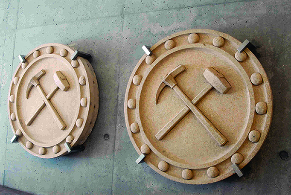 Terracotta “pick and hammer” medallions, like those shown here,  once graced the exterior of the old Mines Building.