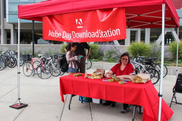 Margaret Witbeck works at a download station during the 2014 Adobe Day.