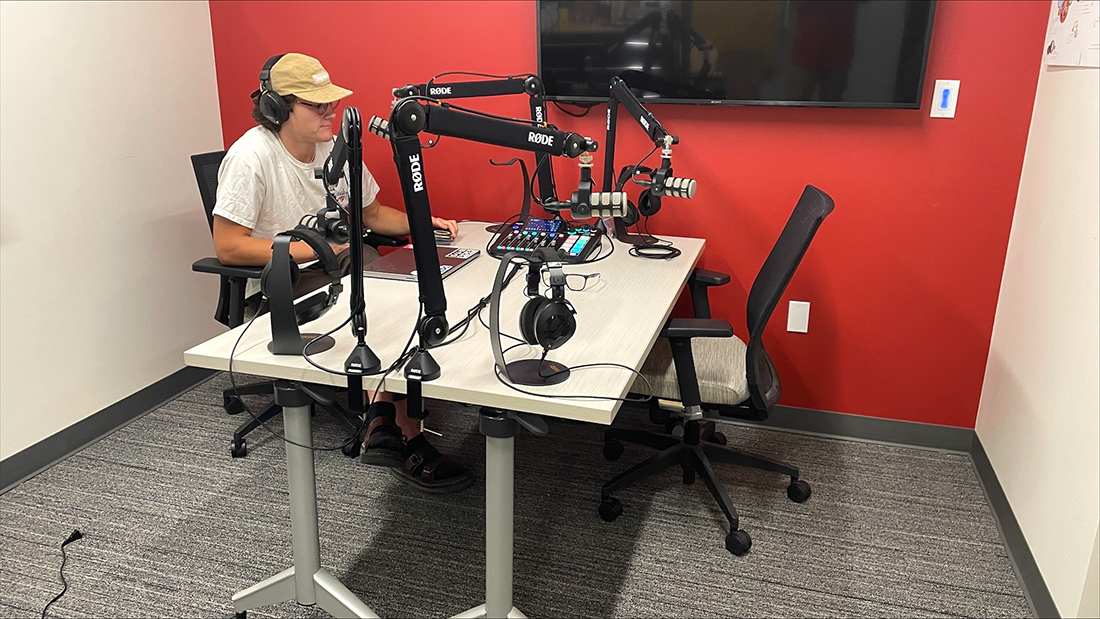 Drew Dennison, Adobe creative consultant, uses a new podcast studio in Kahlert Village. Image courtesy of Tony Sams.