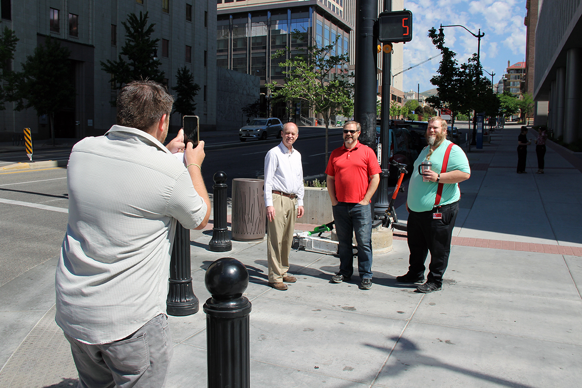 Deputy Chief Information Officer (DCIO) organization employees snap a photo with a traffic light, one of the clues in a DCIO Scavenger Hunt on June 12, 2024, in downtown Salt Lake City.
