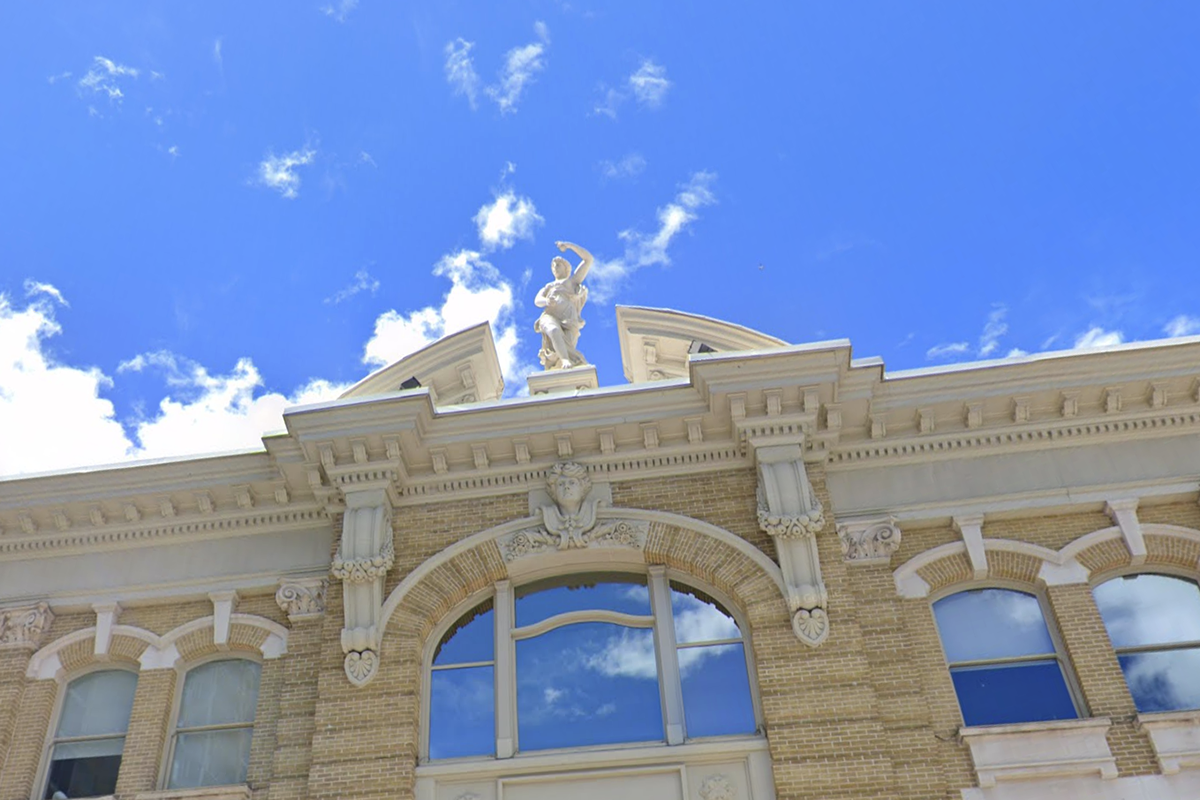 The statue seen here, a clue in the scavenger hunt, adorns the cupola of an office building located at 132 S State Street.