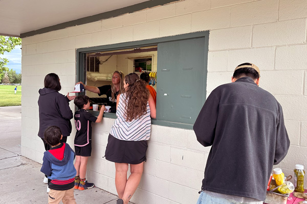 Winters (center, behind the counter) helps customers on June 3, 2024, at the Riverside Snack Shack. (Photo by Larrisa Beth Turner)