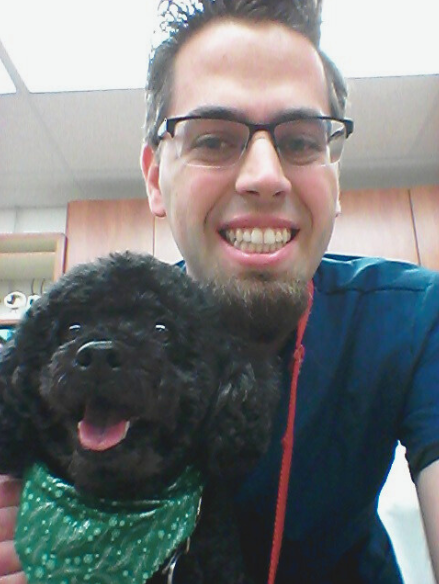 UIT’s Nate Bradford poses with one of his pat patients at Banfield Pet Hospital.