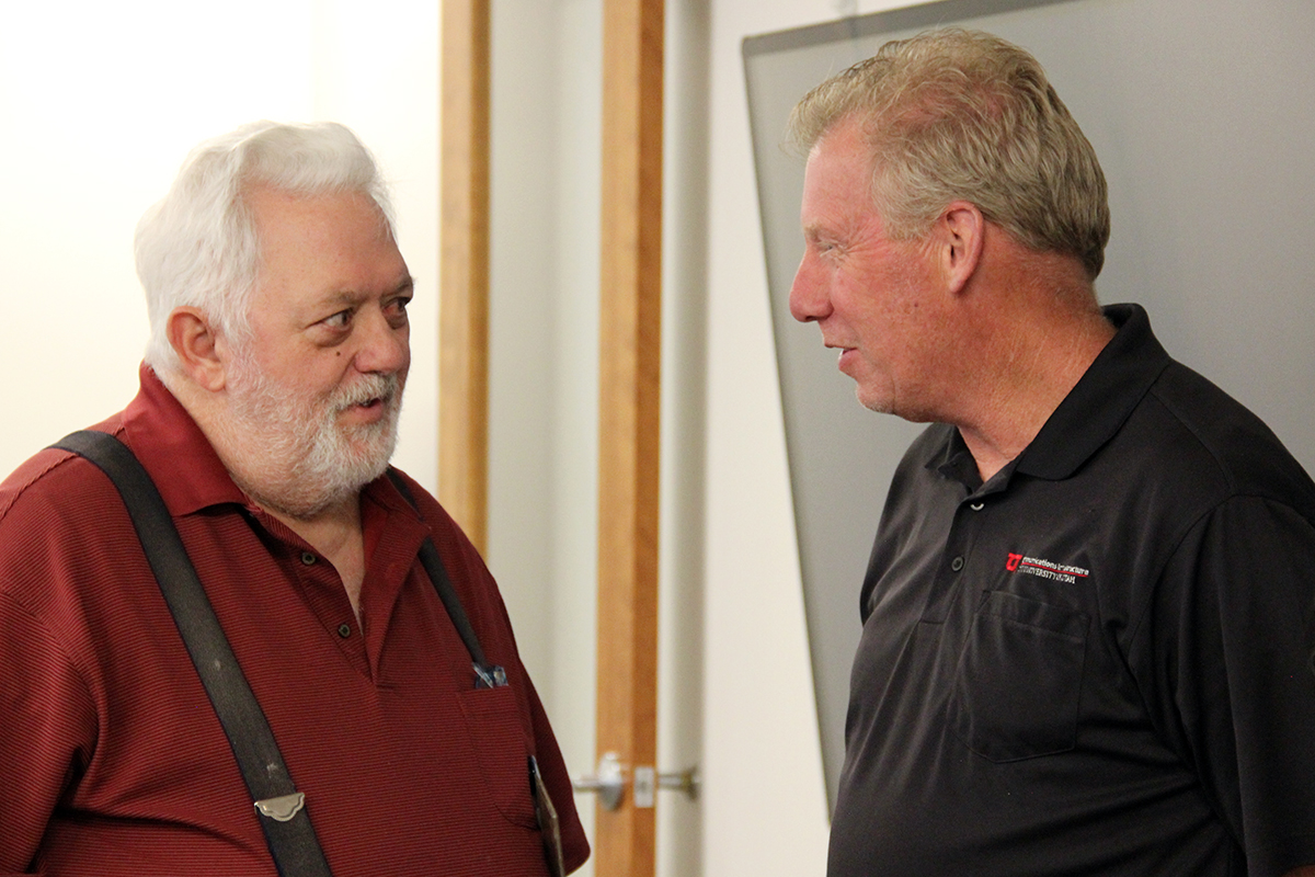 Network Engineer Rick Titus, left, speaks with Account Executive Todd Smith at a retirement reception for Titus on April 23, 2025. Titus has worked for the University of Utah and UIT for a combined 35 years.