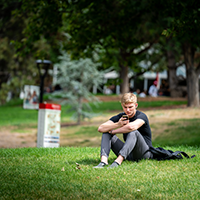 A University of Utah student uses his smartphone outside