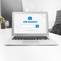 An open laptop with a job search webpage on the screen.