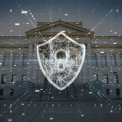 A photo illustration of a white translucent shield with a keyhole overlaying a darkened image of the University of Utah's Park Building.