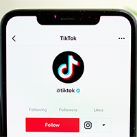 A smartphone is open to the TikTok mobile app.