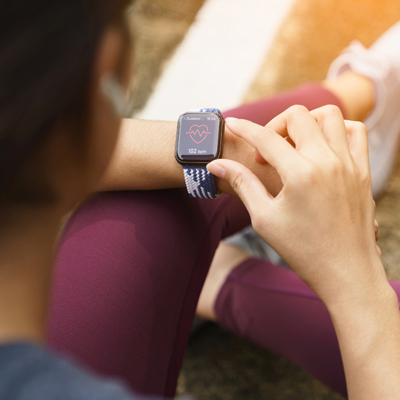 A woman checks her heartbeat on her Apple Watch.