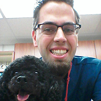 UIT’s Nate Bradford with one of his pet patients during his time working at a Banfield Pet Hospital location in Oxnard, California.