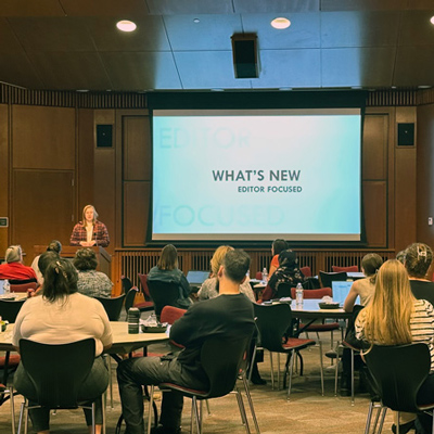 Abbey Allen, left foreground, gives a presentation on what's new in Modern Campus CMS on October 15, 2024, in Gould Auditorium in Marriott Library.