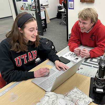 Adobe Creative Consultants Olivia Etz, left, and Canyon Sargent speak with each other at Adobe Creative Commons in Kahlert Village on January 17, 2025.