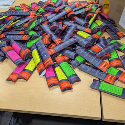 Cartons that contain bottles of naloxone and syringes.
