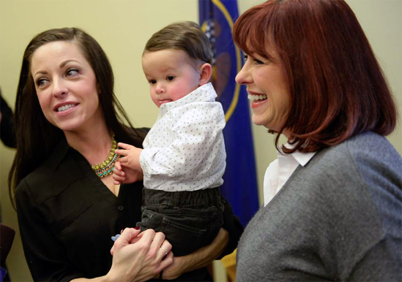 Erin Finkbiner holds her son Max Puente, 1, in this photo taken in January at the Utah state capitol. At right is her mother, Jan Lovett  facilities coordinator in UITs Strategic Planning.