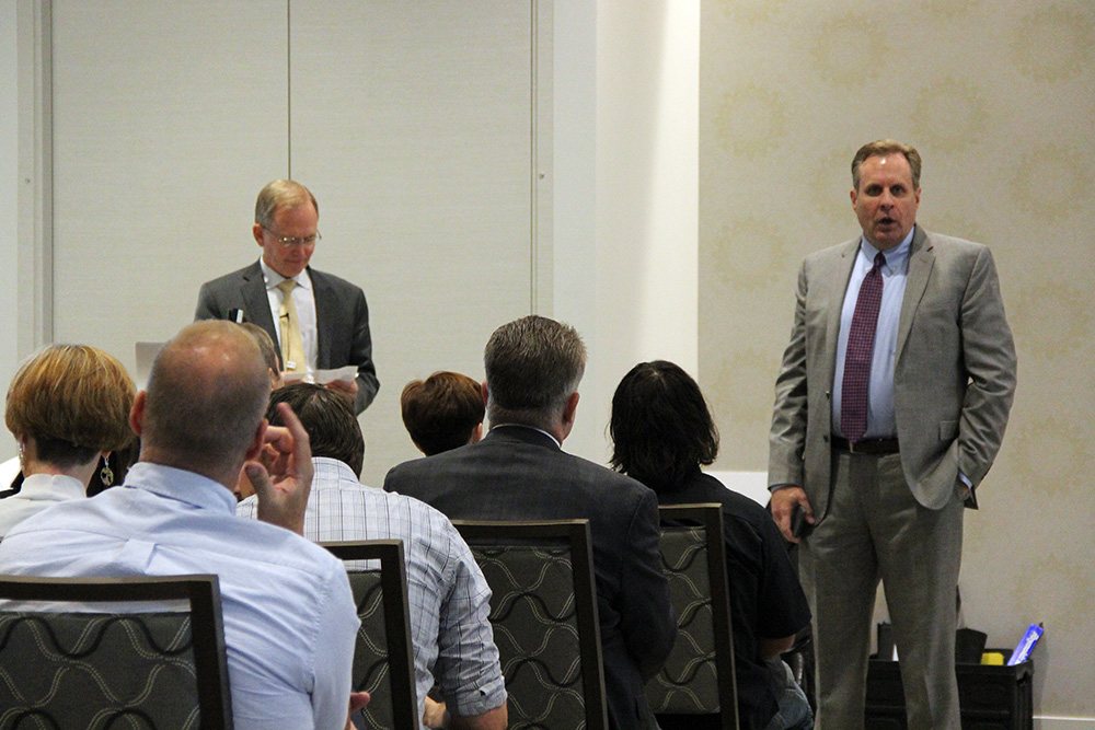 CIO Steve Hess tasks CTO Jim Livingston with answering a question submitted by a UIT employee during a Q&A session at the September 17 All-Hands Meeting at the Alumni House.