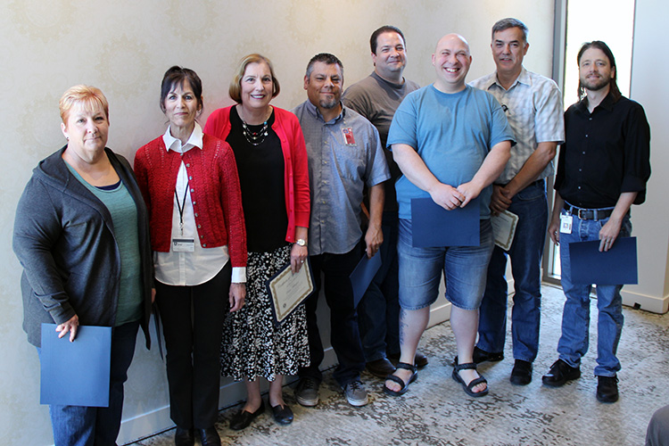 L-R: Teri Pearson, Robin Horton, Paula Millington, Doug Johnson, Brian Haymore, Dave Richardson, Dave Packham, and Corey Roach were honored for 20 years of service to UIT during the September 17 All-Hands Meeting at the Alumni House.