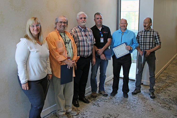 L-R: Caprice Post, Cody Hudson, Bryan Harman, Lance Davis, John Wardle, and Mike McCloskey were honored for 25 years of service to UIT during the September 17 All-Hands Meeting at the Alumni House. Not pictured: Jonzy Jones and Anita Orendt.