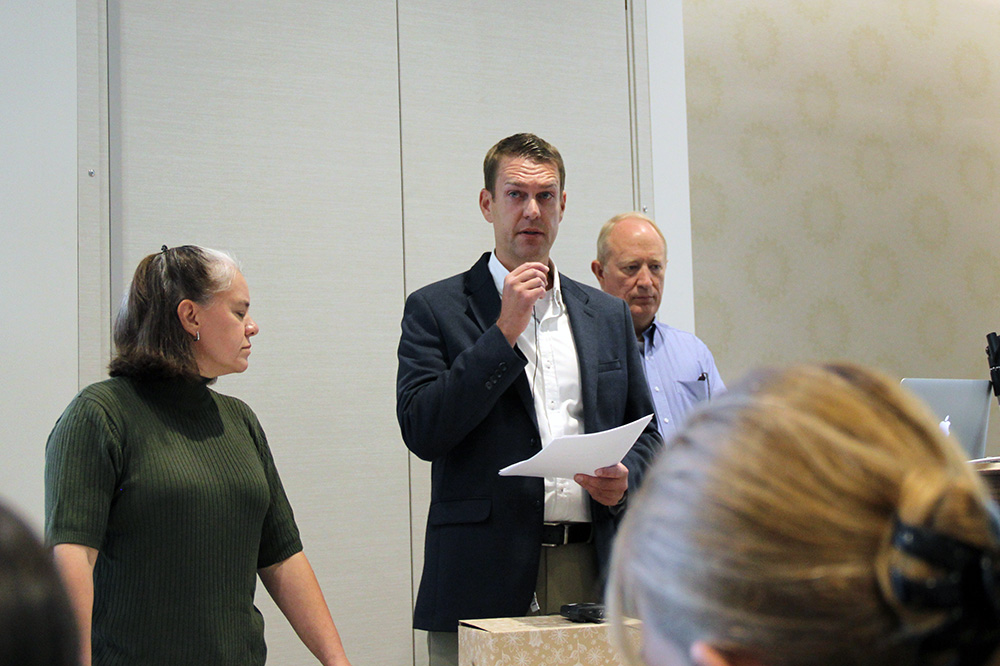 L-R: Kevin Taylor Memorial Service Award committee members Shellie Eide, Jesse Drake, and Bryan Morris prepare to announce this year's nominees and winner during the September 17 All-Hands Meeting at the Alumni House.