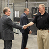 CIO Steve Hess is greeted by DDC Warehouse Storekeeper David Young.