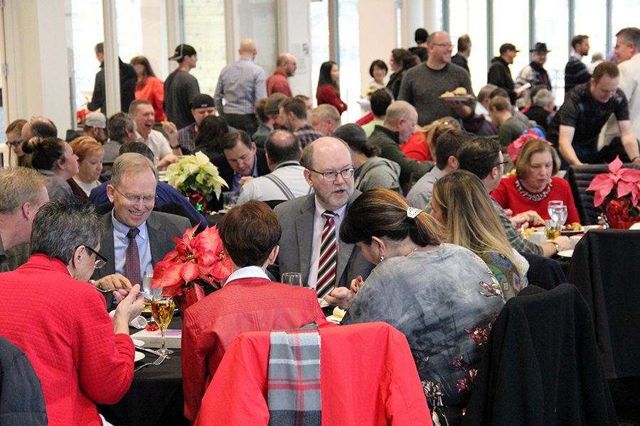 University Information Technology employees were joined by Senior Vice President Dan Reed, center (striped tie), at the 2018 UIT Employee Holiday Luncheon and Prize Drawing on December 11 at the Cleone Peterson Eccles Alumni House. On Reed's left is Chief Information Officer Steve Hess.