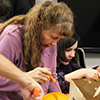 USS pumpkin-carving contest: Lani Twitchell, center, and Kelsey Loizos, right. Loizos earned third place for "The Nightmare Before Christmas." 