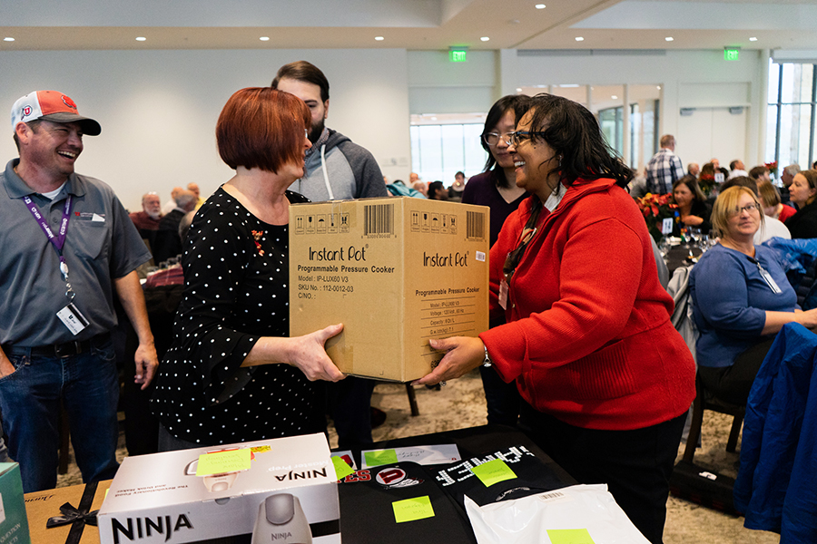Syndi Haywood, right, wins an Instant Pot during a round of prize drawings on Thursday, December 5, 2019 at the UIT Holiday Luncheon (photo credit: Alijana Kahriman).