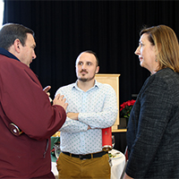 UIT Deputy CIO Ken Pink, from left, Associate Director for Business Intelligence Tom Howa, and Special Assistant for Strategic Affairs Stacy Ackerling talk during the Student Affairs winter luncheon.