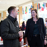 Dane Luby and Special Assistant for Strategic Initiatives in Student Affairs Stacy Ackerlind talk during the Student Affairs winter luncheon.